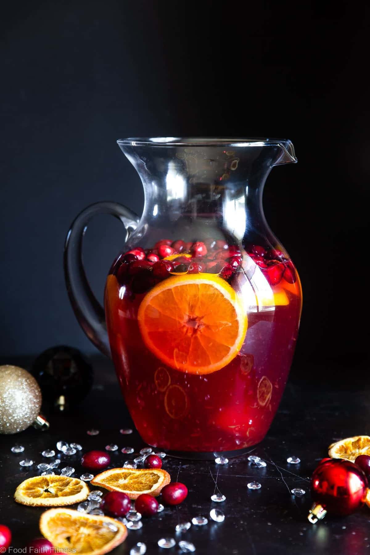 Sparkling Holiday Champagne Sangria - Full of tart cranberries and sweet oranges, this is an easy, better-for-you cocktail that is perfect to serve a crowd this Holiday season! Fizzy, festive and tasty! | #Foodfaithfitness | #Glutenfree #Sangria #Dairyfree #Vegan #Champagne