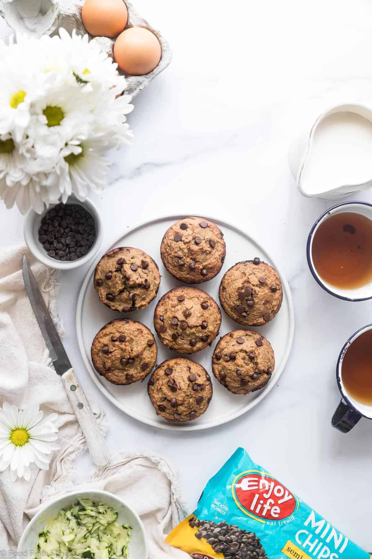 Healthy Gluten Free Zucchini Muffins - These dairy free Zucchini Muffins are fluffy and gluten, dairy, oil and sugar free! Sweetened with dates, studded with chocolate chips and only 170 calories! Great for kids and adults! | #Foodfaithfitness | #Glutenfree #Dairyfree #Healthy #Zucchini #sugarfree