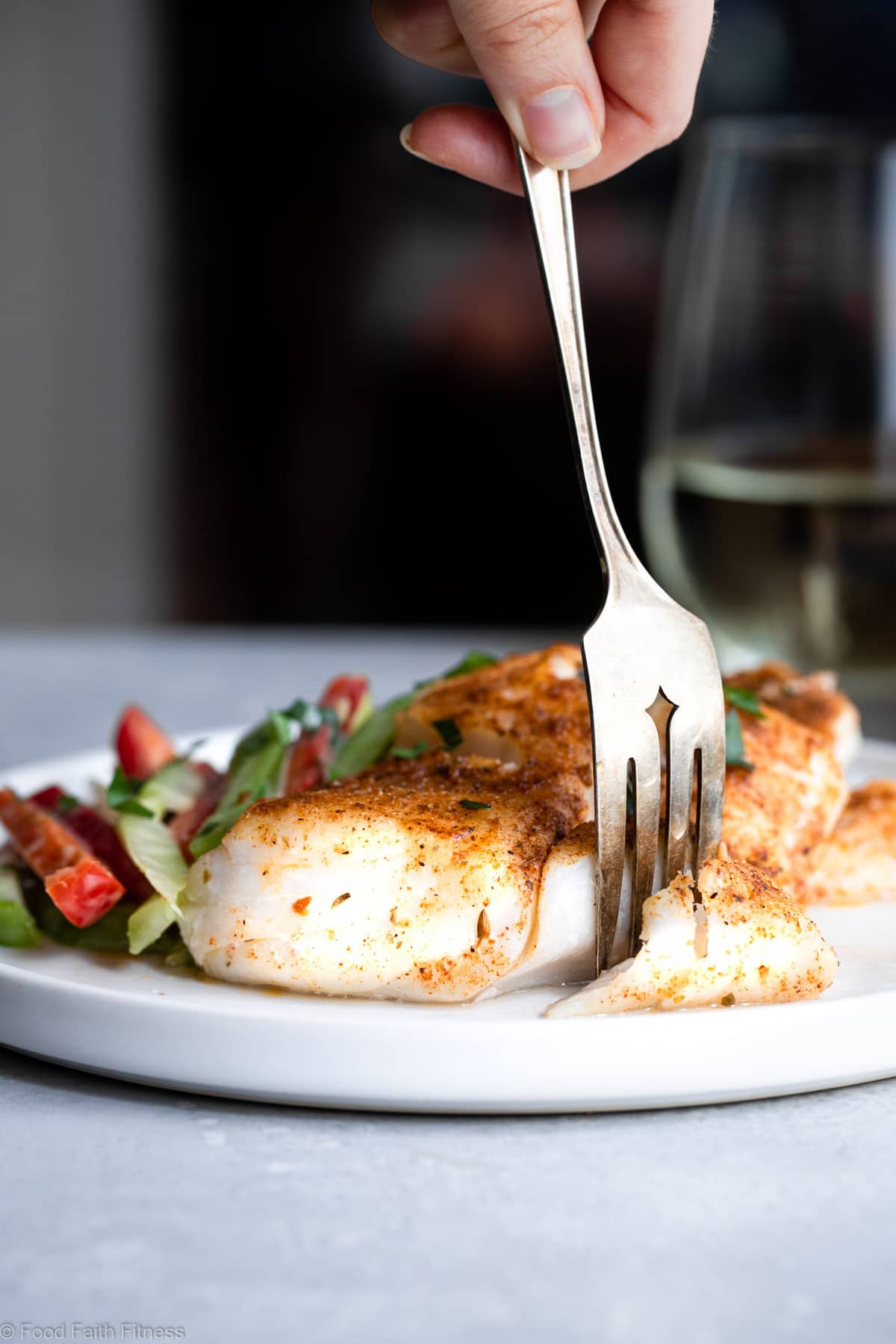 Cutting Cajun Grilled Cod on a plate