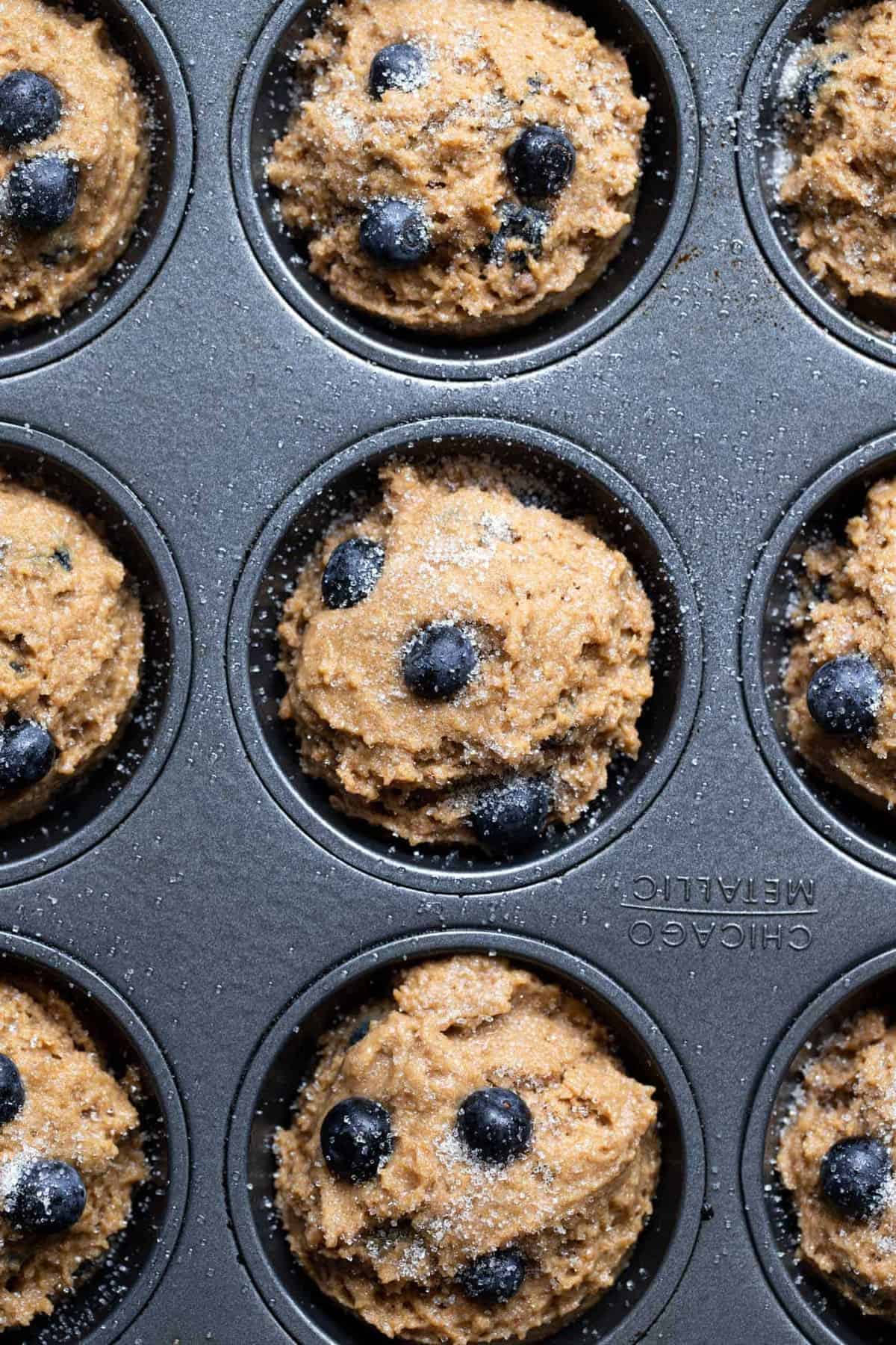 Close up of whole grain blueberry muffins in a muffin pan