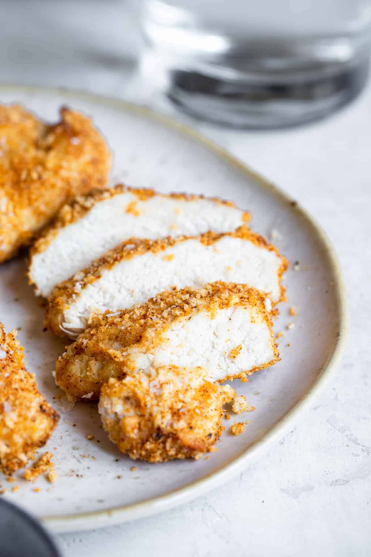 close up photo of sliced Air Fryer Breaded Chicken Breast on a plate