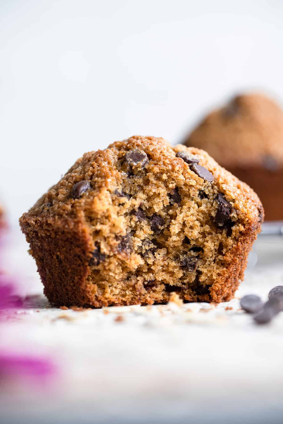healthy chocolate chip muffins with a bite taken out of it