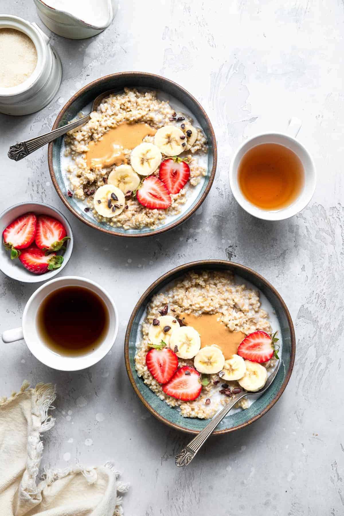 Instant Pot steel cut oatmeal in 2 bowls with strawberries