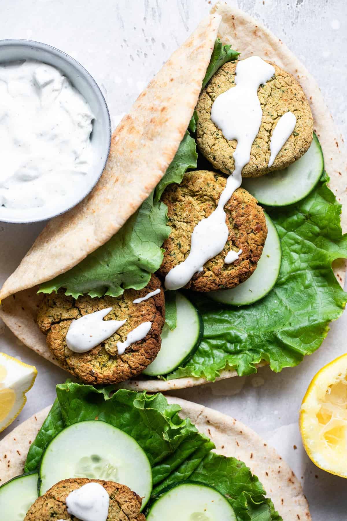 baked falafel in a pita bread with yogurt sauce
