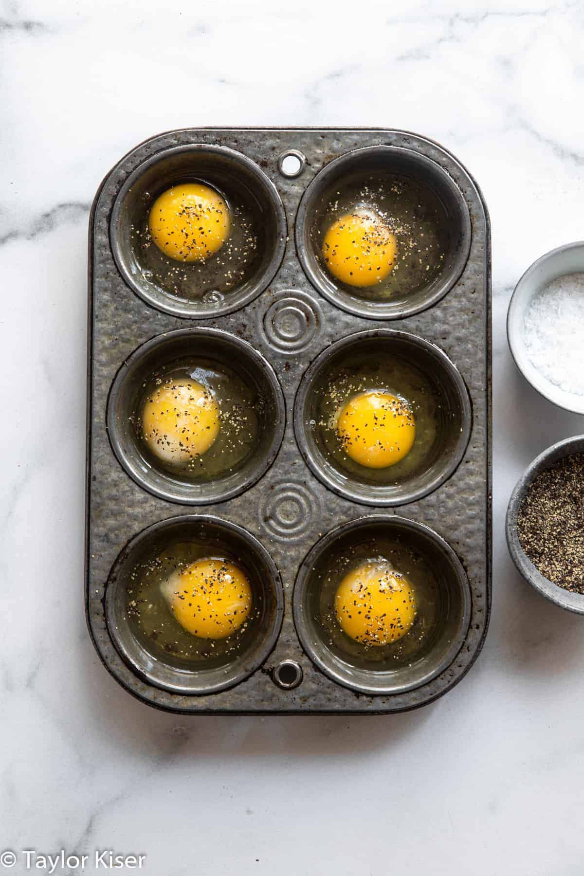 raw eggs in a muffin tin for how to cook eggs in the oven