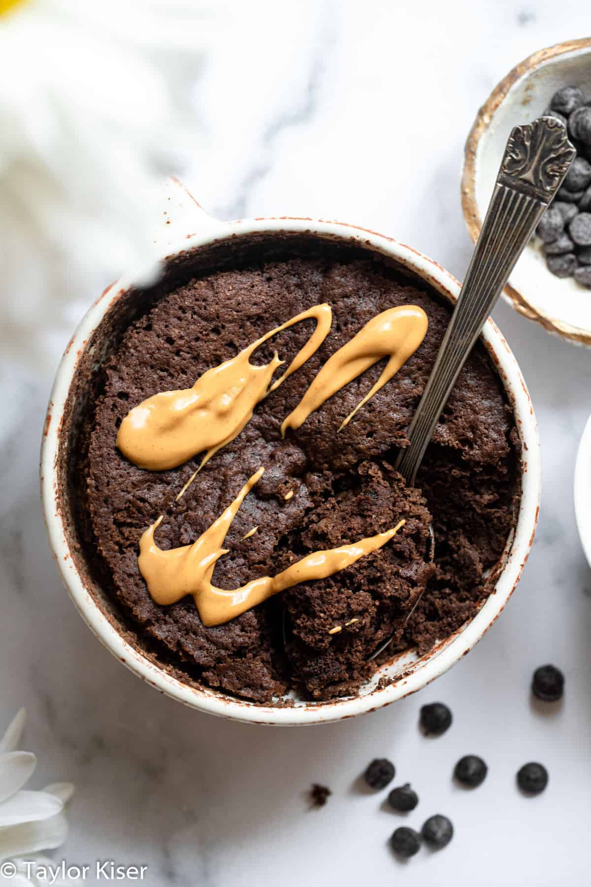 close up of low carb keto mug cake with peanut butter drizzled on top