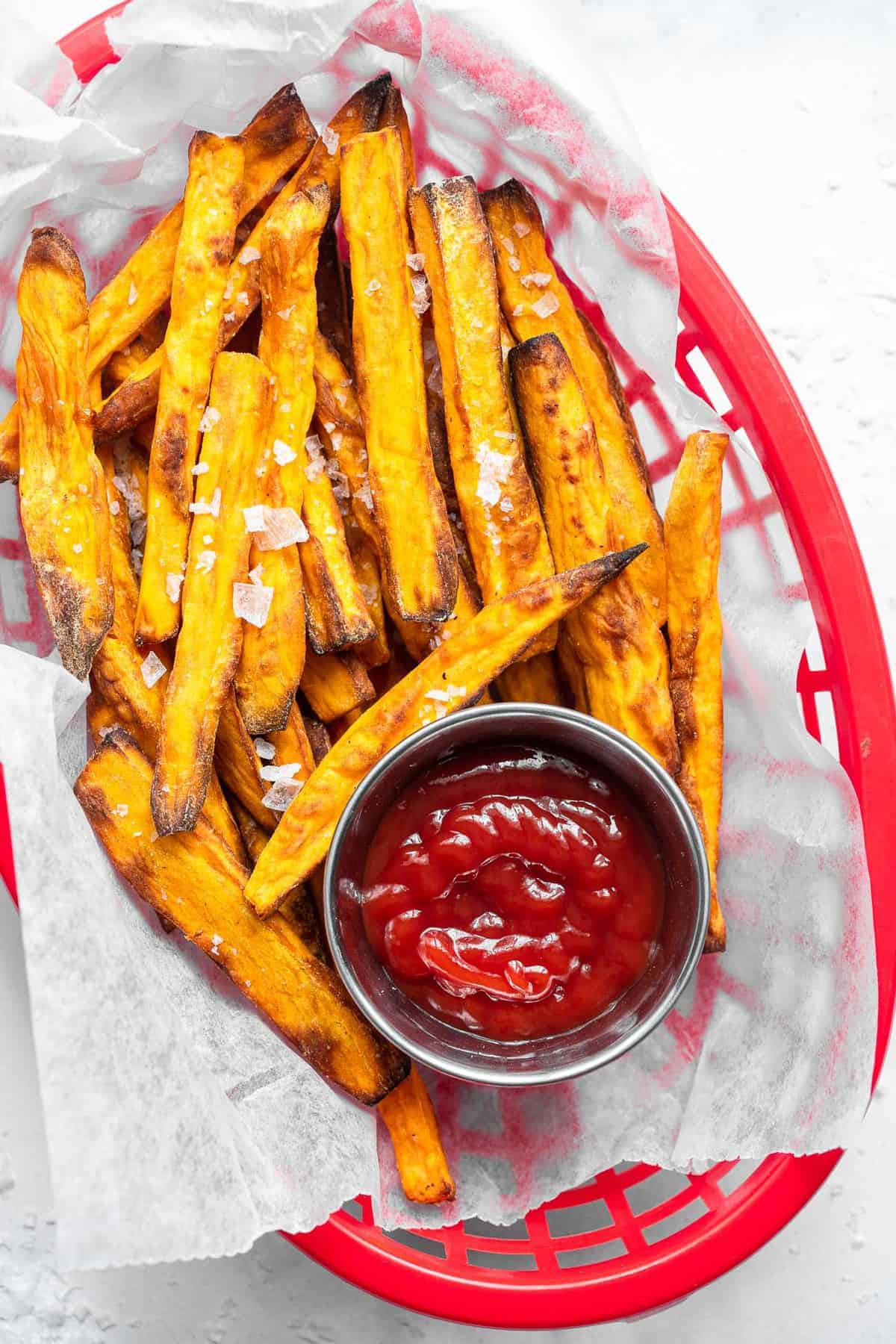 air fryer sweet potato fries in a red diner basket