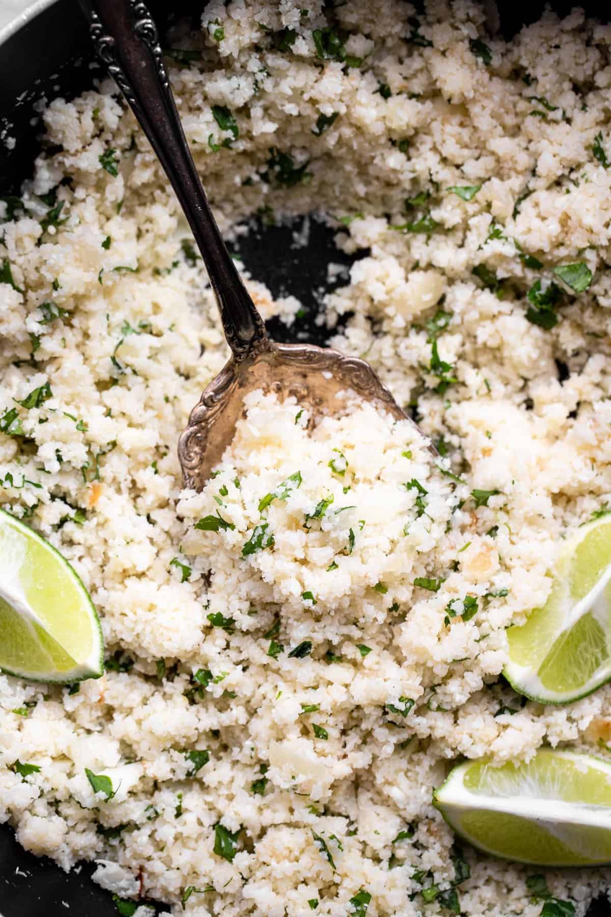 overhead of a skillet filled with cilantro lime cauliflower rice