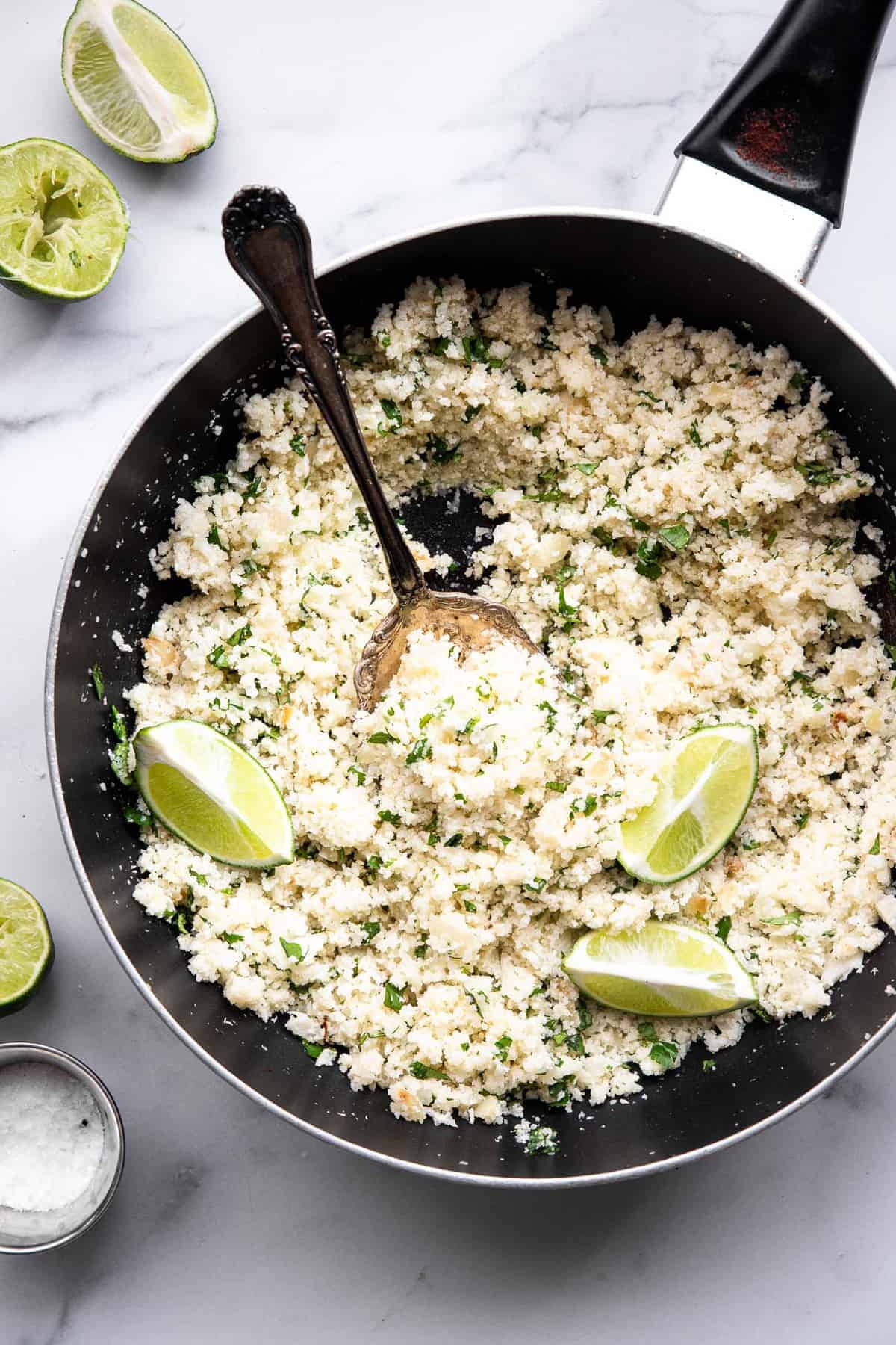 cilantro lime cauliflower rice in a skillet on a table