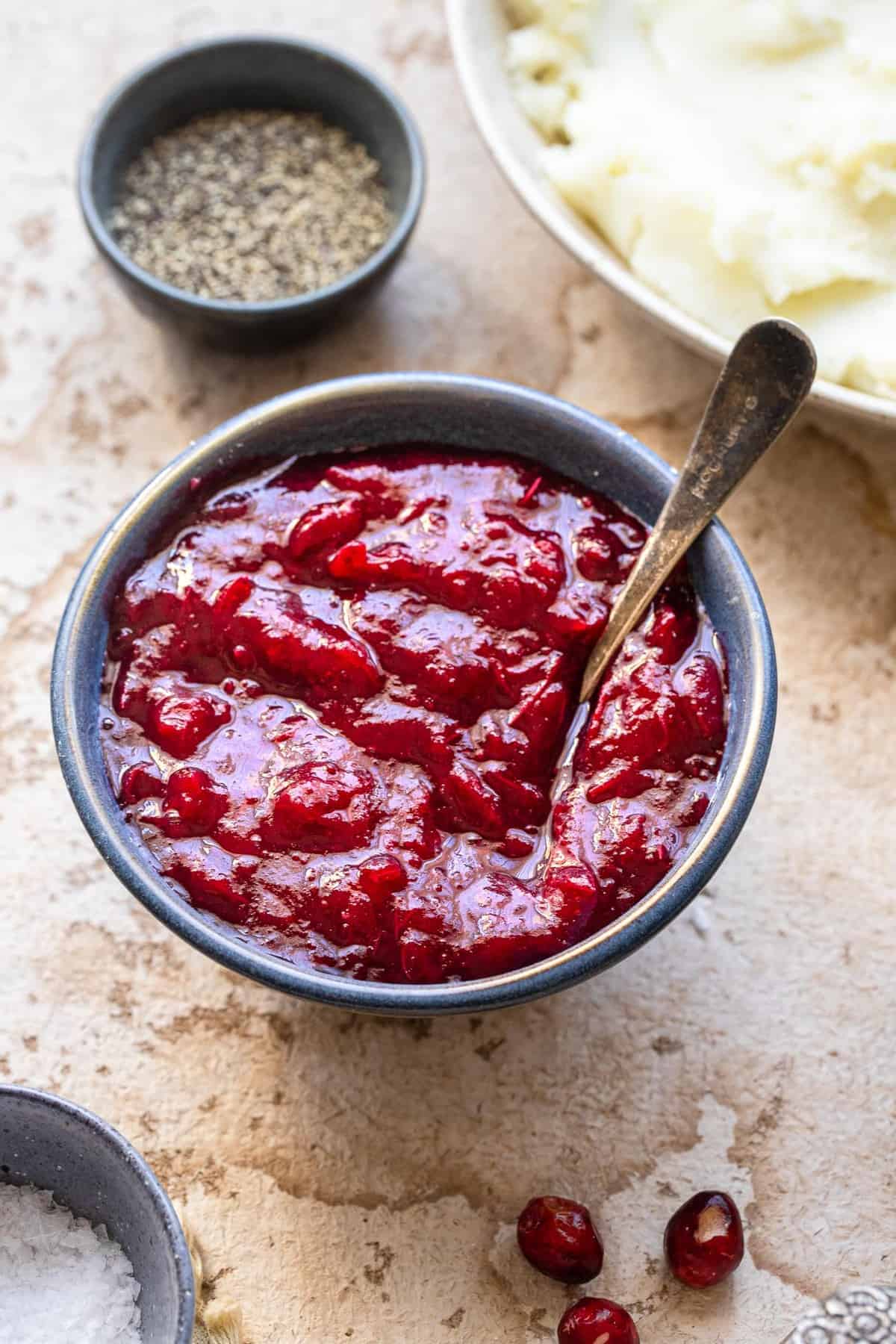 low carb keto cranberry sauce in a blue bowl with a spoon