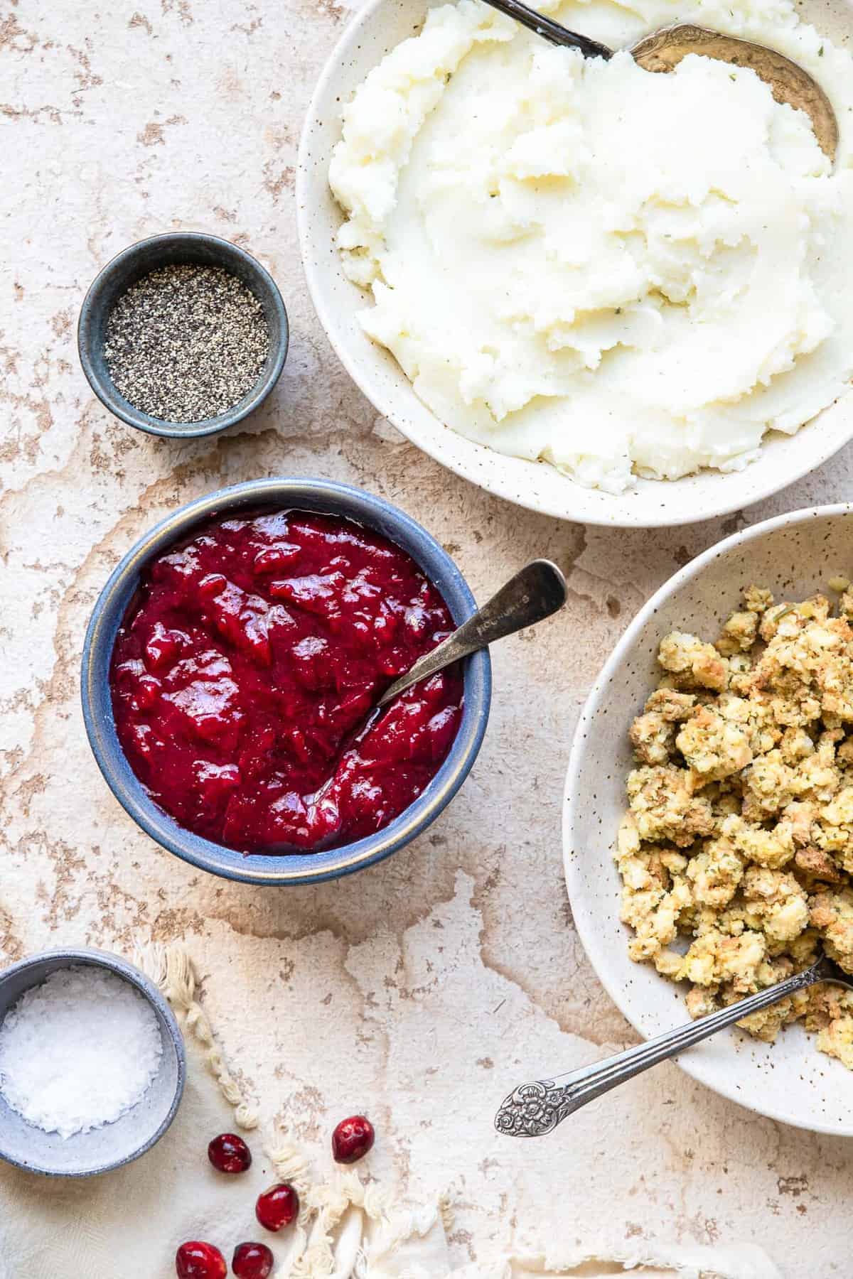 sugar free cranberry sauce on a table with stuffing and mashed potatoes