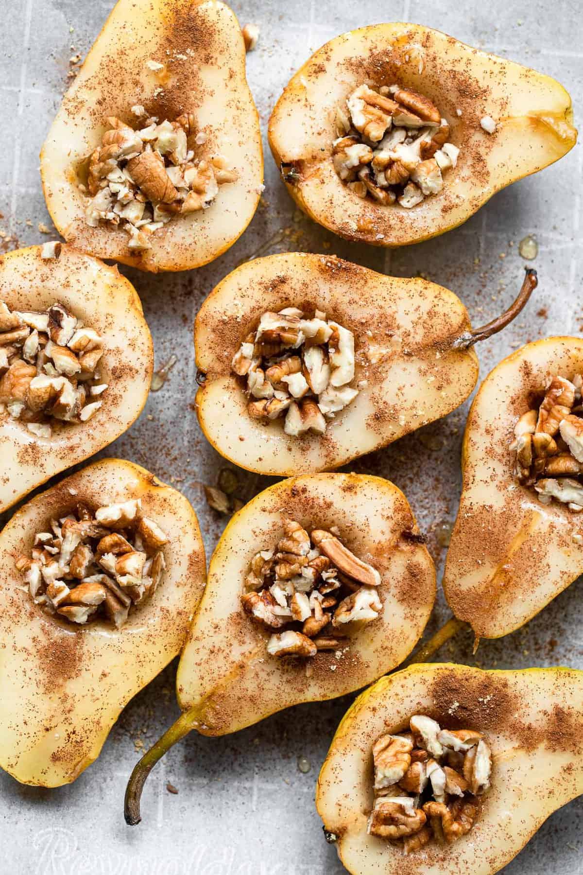 whole baked pears on a baking sheet