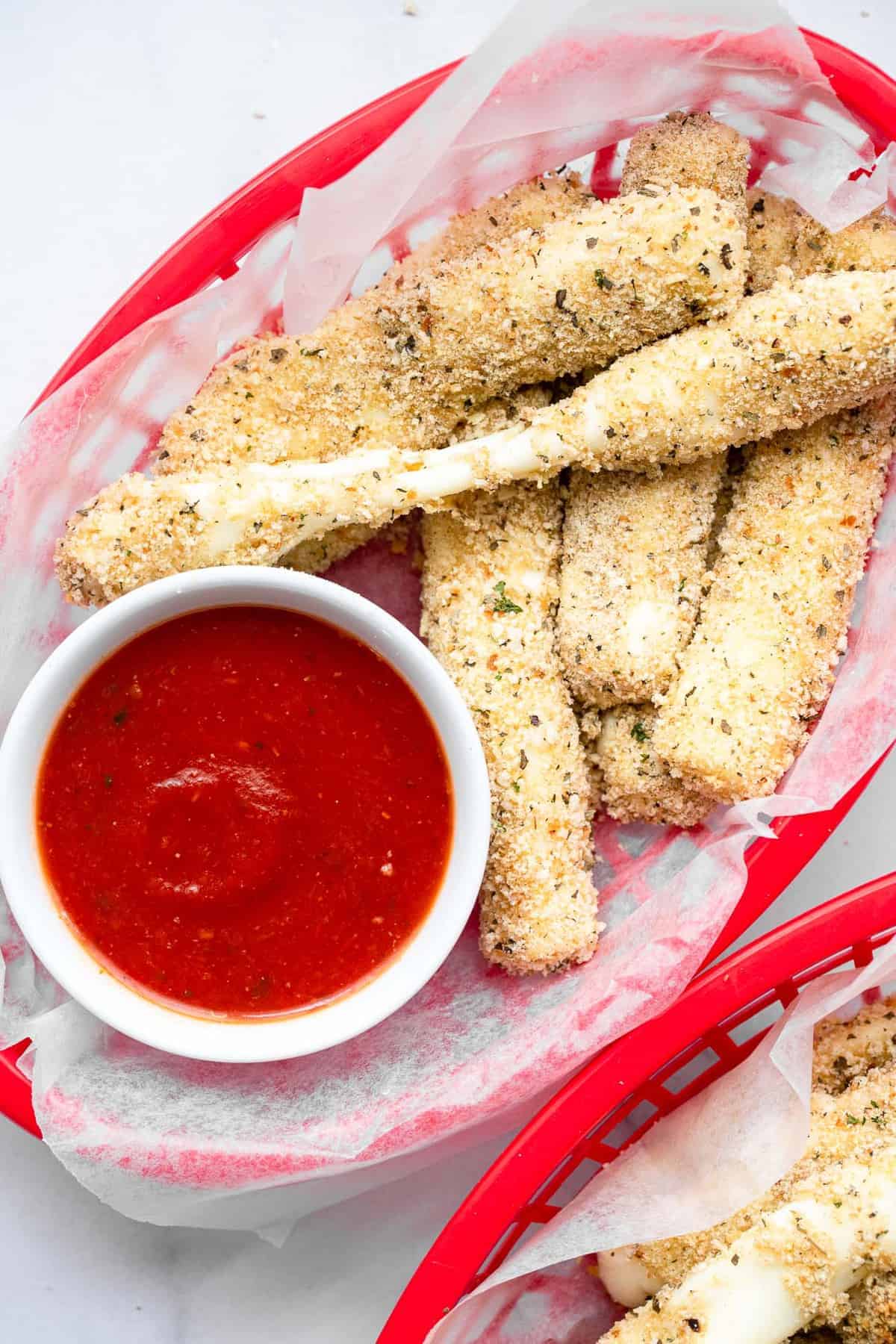 oven baked mozzarella sticks pulled apart with dip