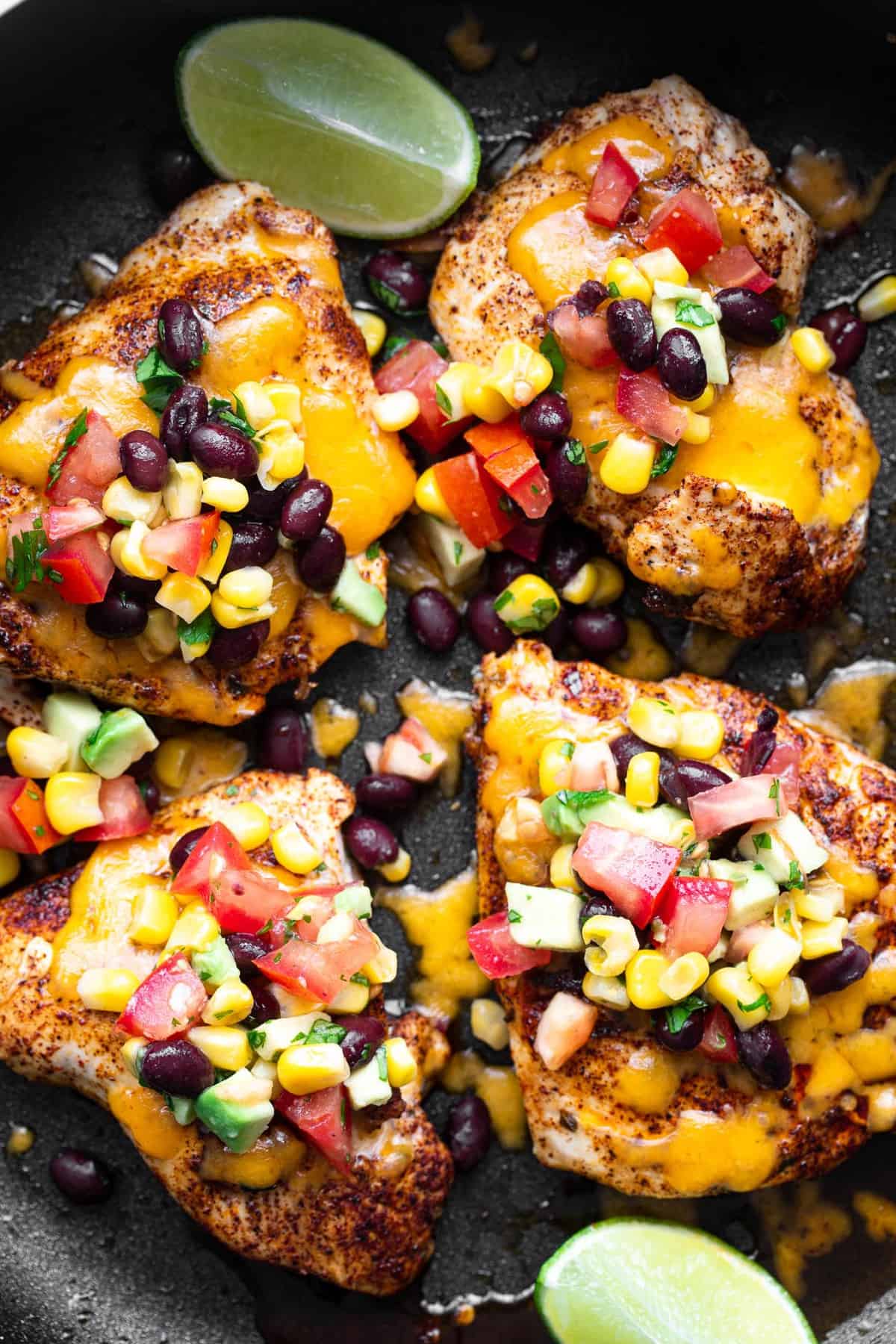 black bean salsa chicken in a skillet covered with cheese