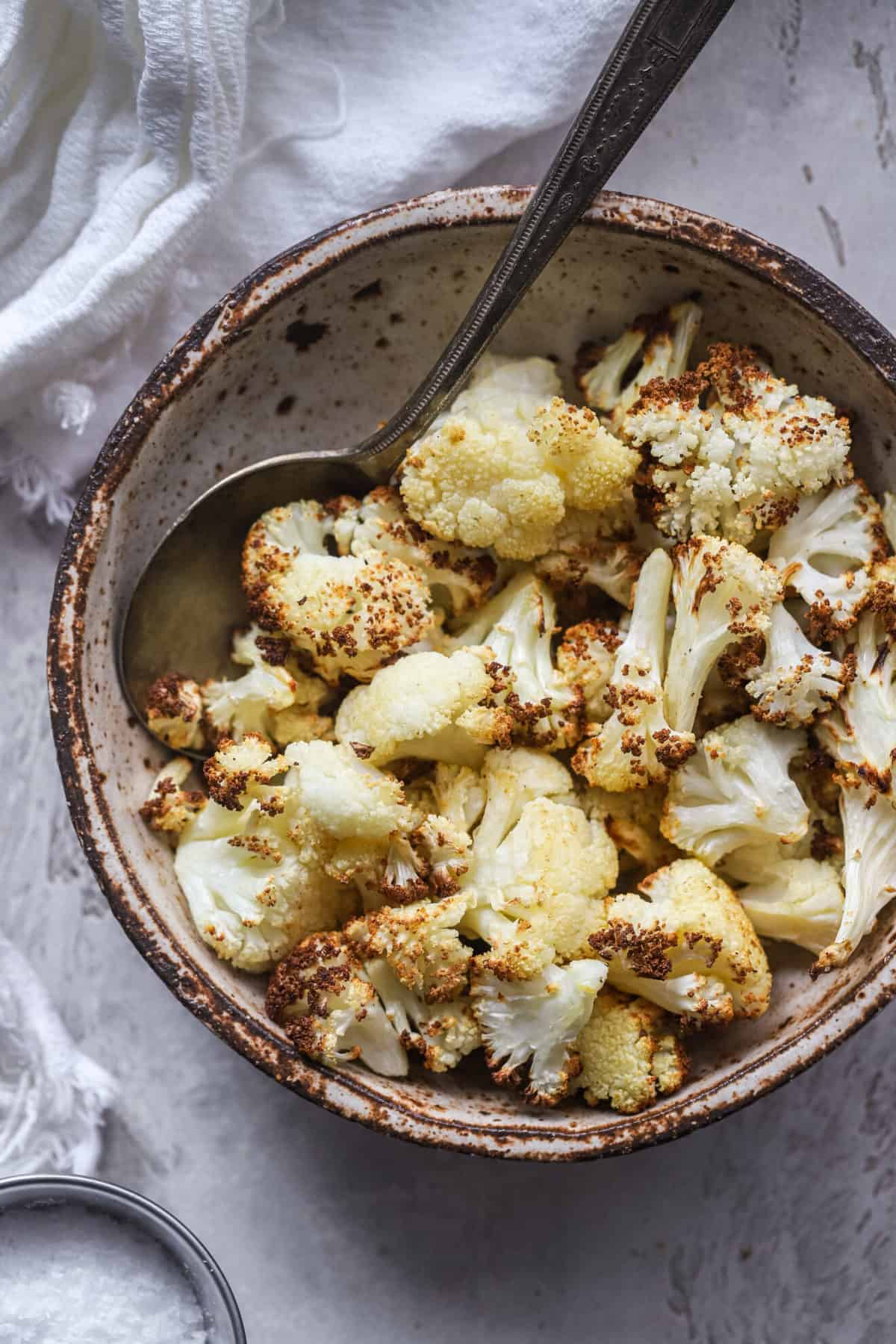cauliflower air fryer close up in bowl with spoon