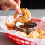Air Fryer Coconut Shrimp in basket with dipping sauce