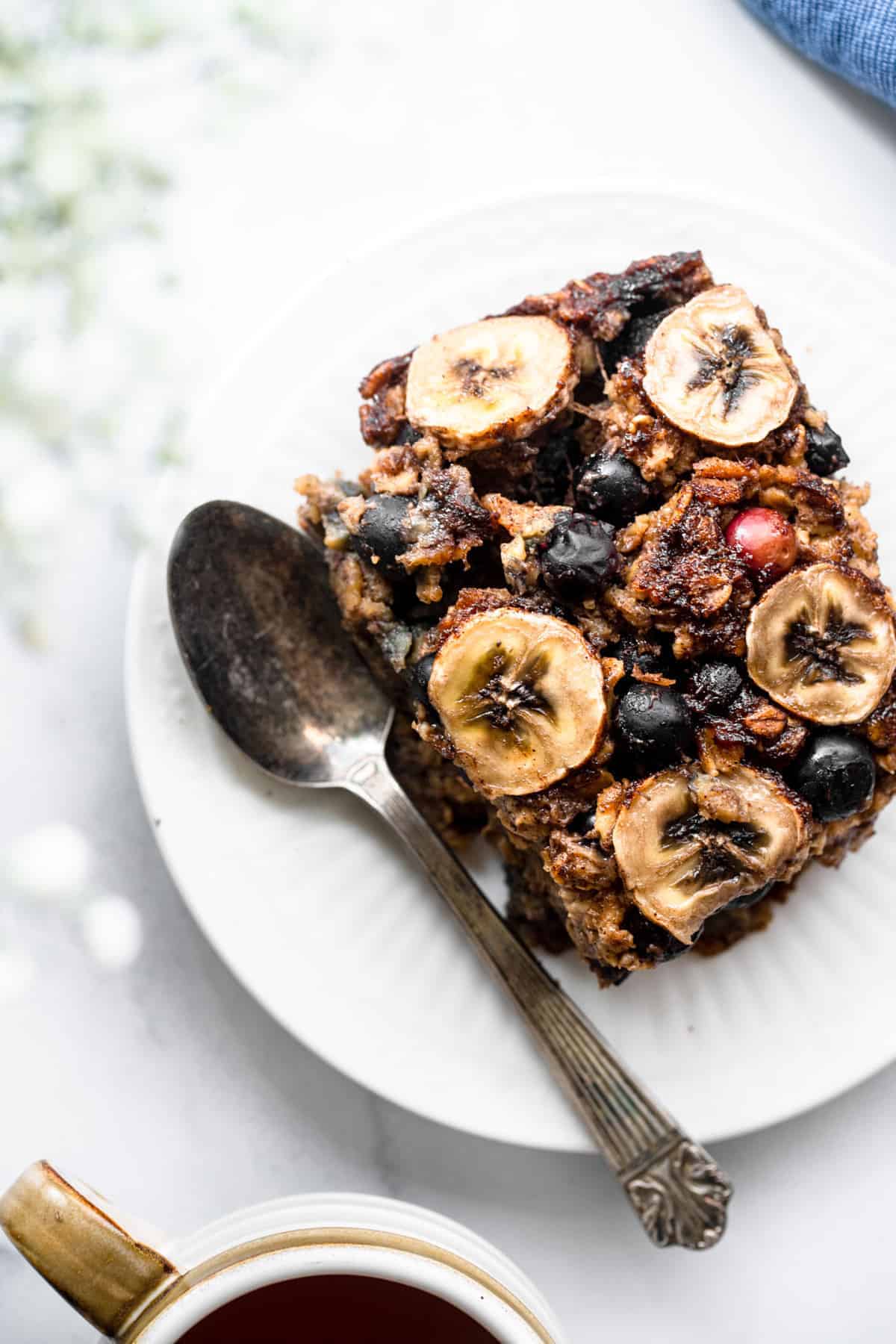 Blueberry Banana Baked Oatmeal on a plate with spoon