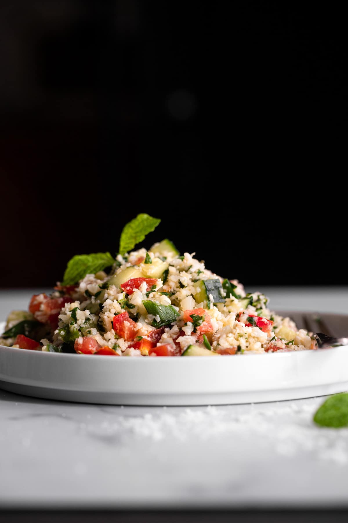 side photo of Cauliflower Tabbouleh on a serving plate 