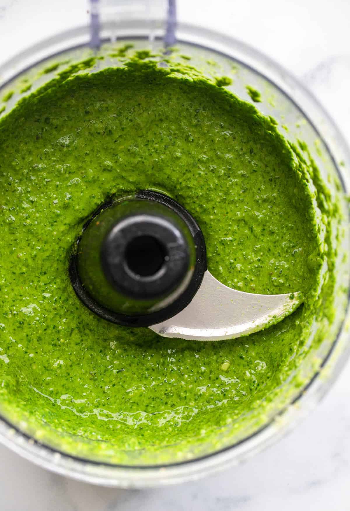Spinach basil pesto in a food processor after being blended