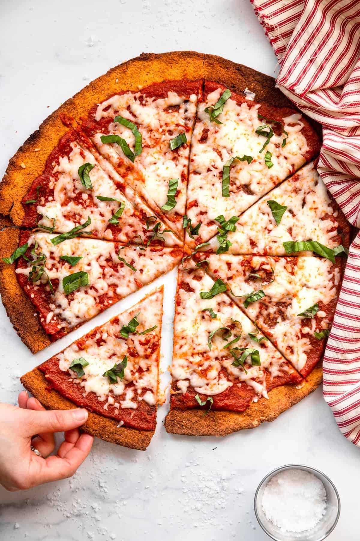 Sweet potato pizza served with cheese, sauce, and basil