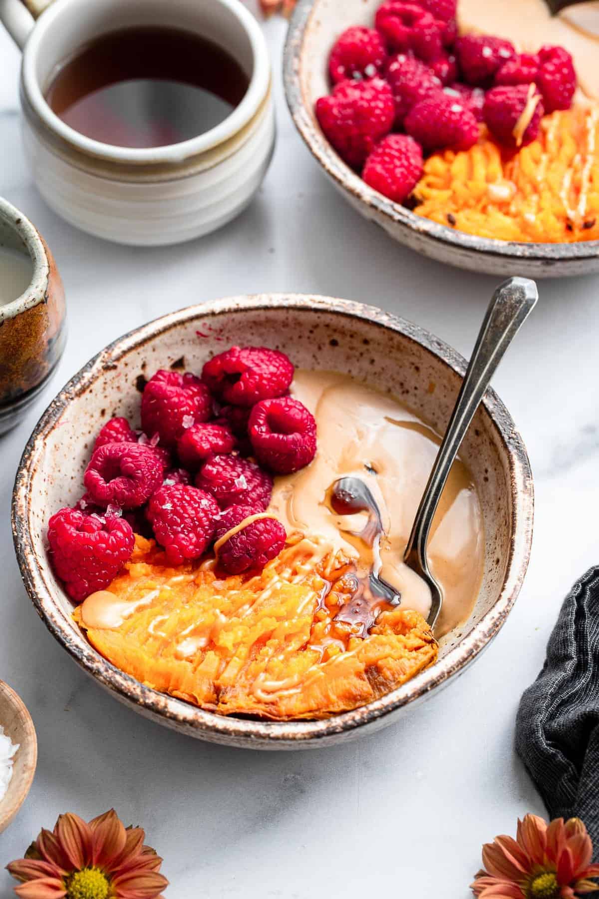 sweet potato breakfast bowl on a table with coffee on the side