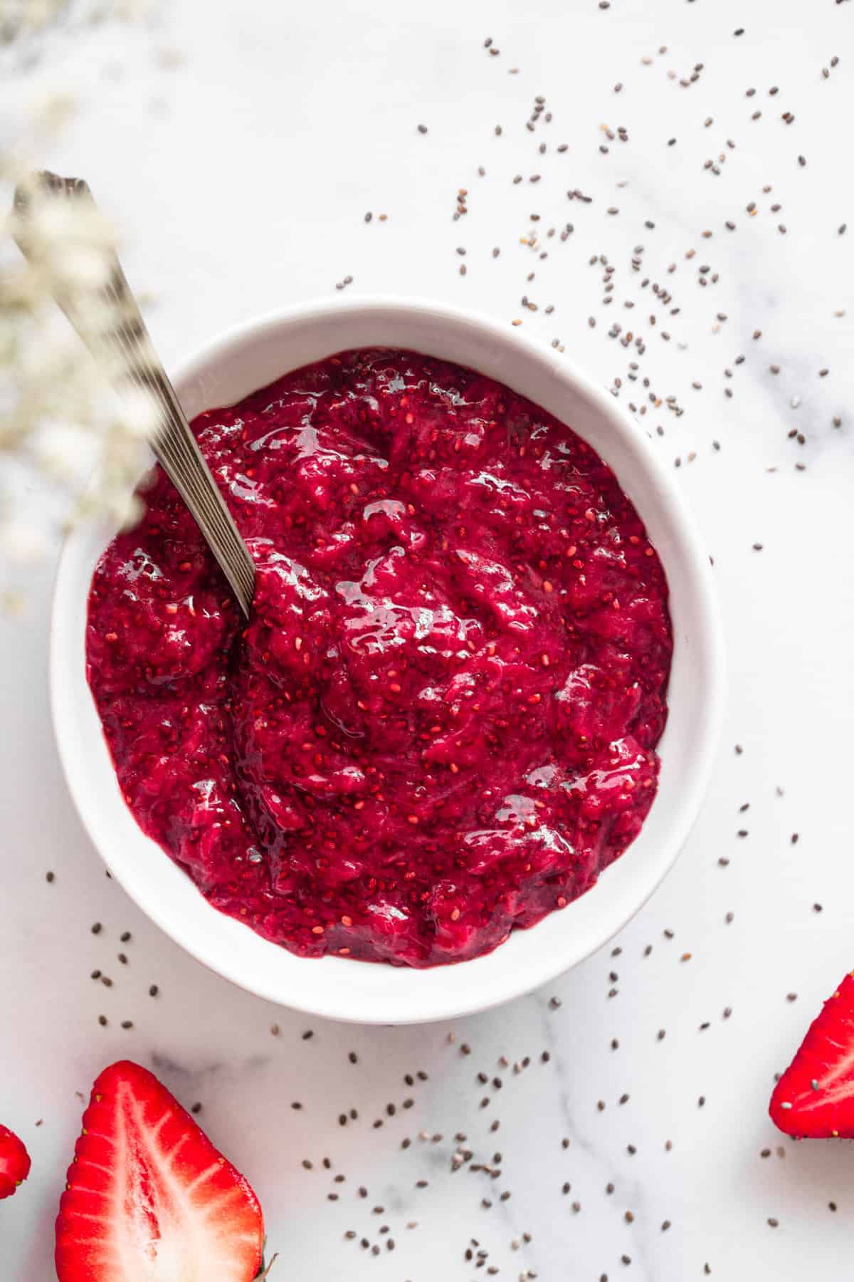 top vie of strawberry chia jam in a bowl with spoon