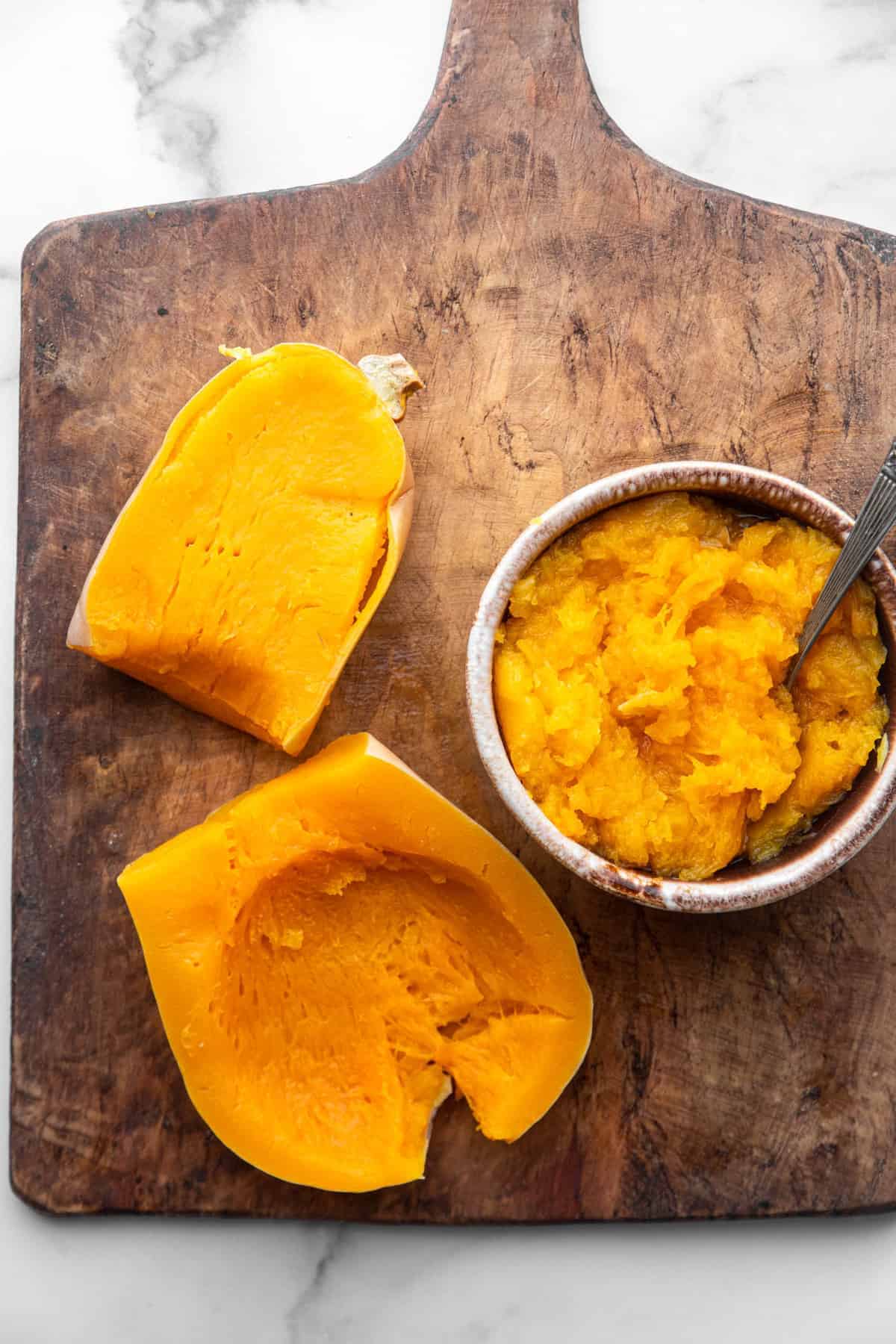 Instant Pot Butternut Squash on a cutting board with inside scooped out