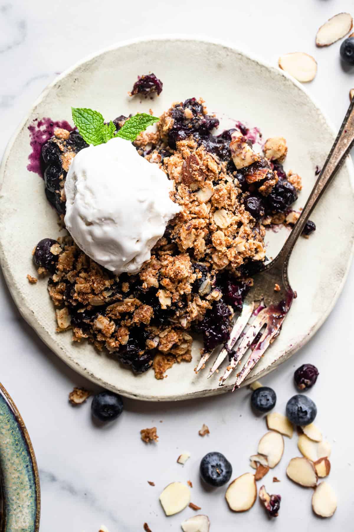 Gluten Free Blueberry Crisp on a plate with a fork on the side
