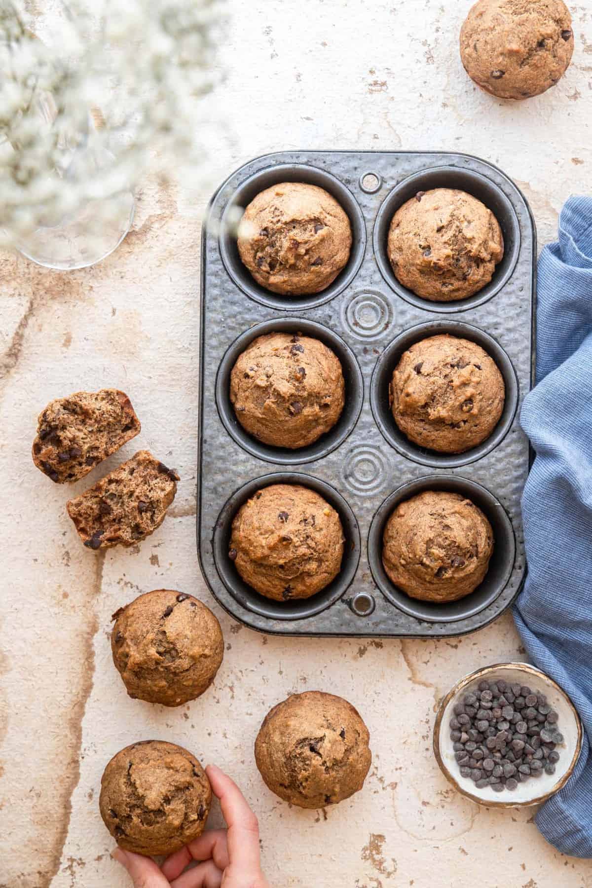 whole wheat banana muffins on a table in a muffin pan