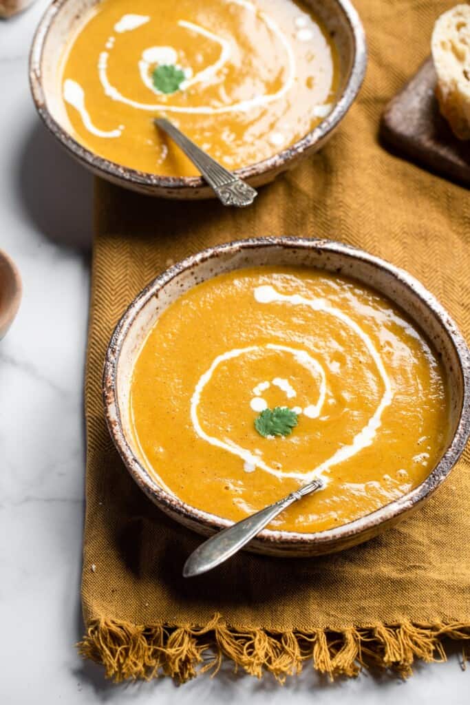Instant Pot Butternut Squash Soup on top of a table cloth with spoon