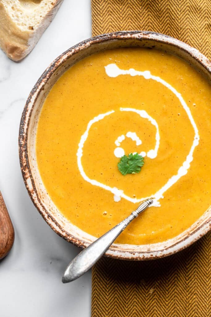 close up of Instant Pot Butternut Squash Soup in a bowl with a spoon