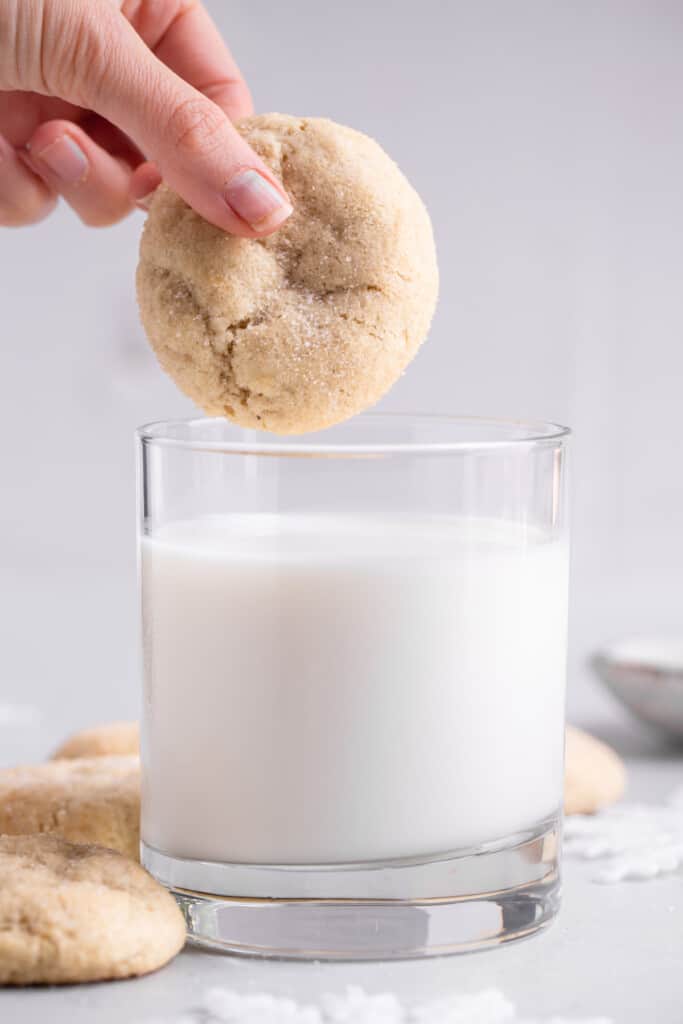 Eggless Sugar Cookies being dipped into milk