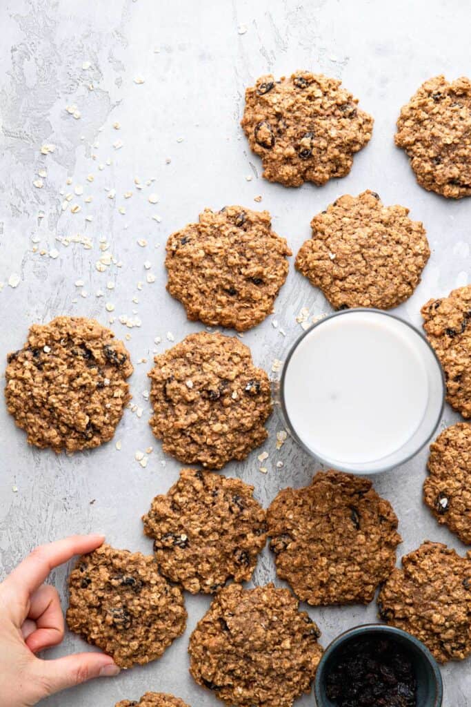 a bunch of Healthy Oatmeal Cookies around a glass of milk