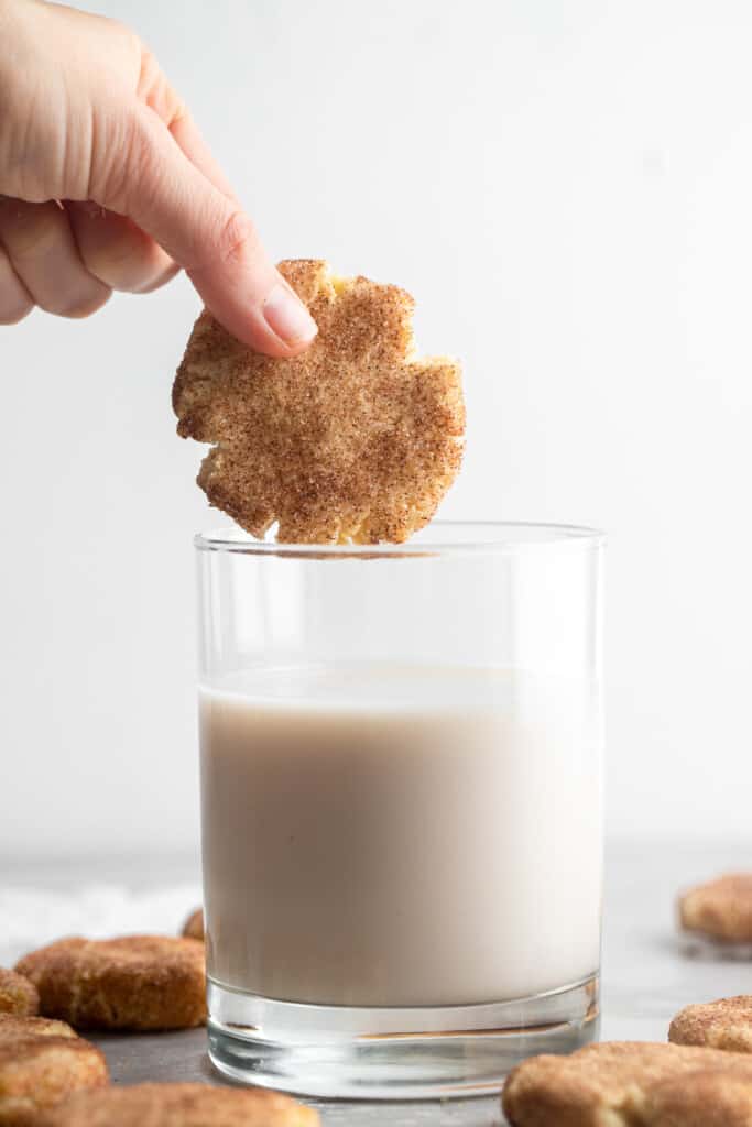 Keto Snickerdoodles being dipped into a glass of milk