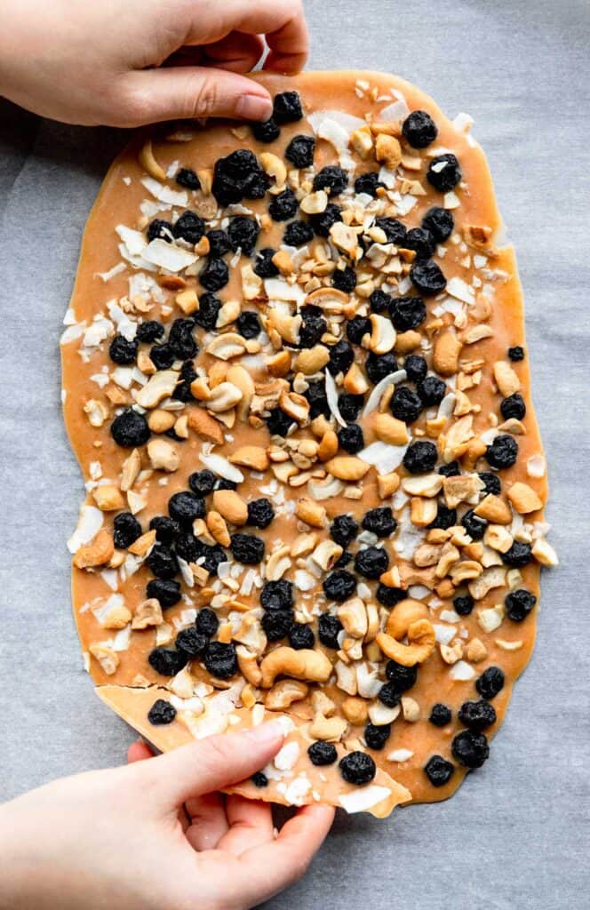 Sweet Potato Blueberry Coconut Cashew Bark being laid on a table