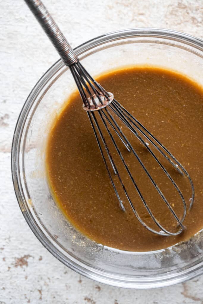 Whole30 Balsamic Vinaigrette in a bowl with a whisk