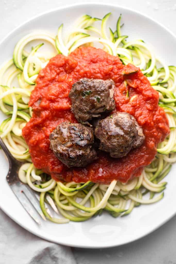 Whole30 Meatballs on top of a plate of noodles