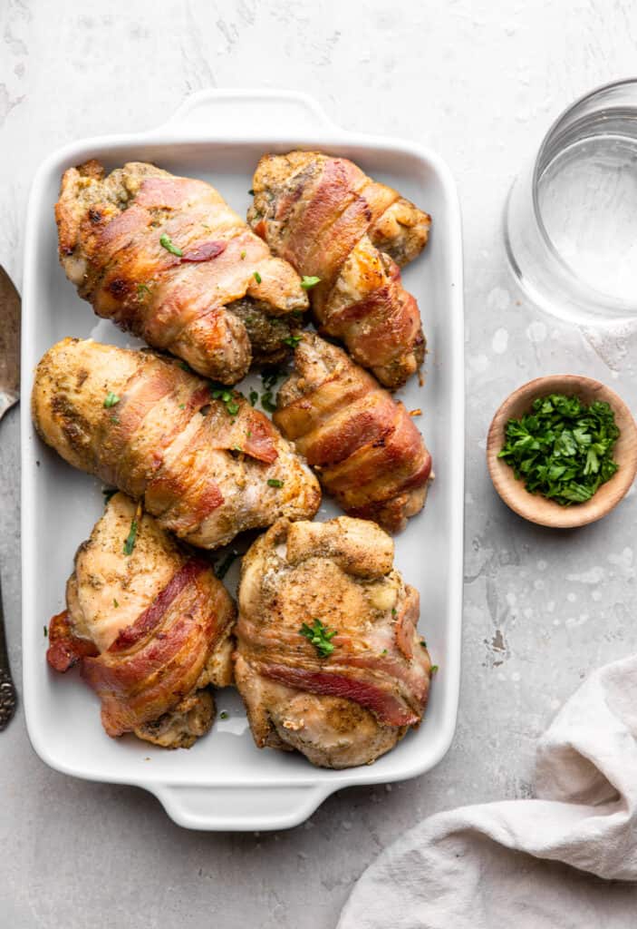 6 Bacon Wrapped Chicken Thighs in a baking dish