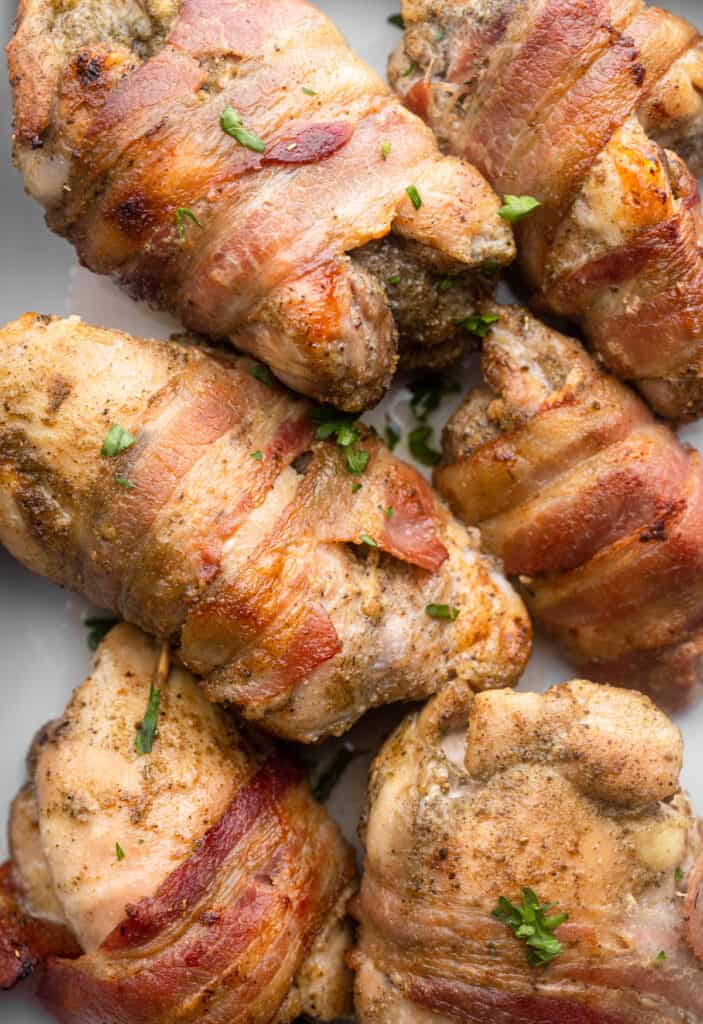 Bacon Wrapped Chicken Thighs on a sheet