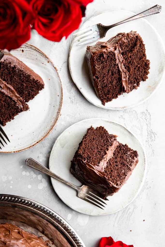 several slices of Dairy Free Chocolate Cake on plates with forks