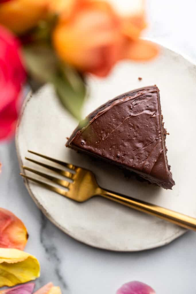 one slice of Instant Pot Chocolate Cake on a plate with a fork