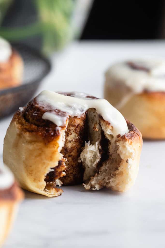 one Air Fryer Cinnamon Roll with a bite taken out