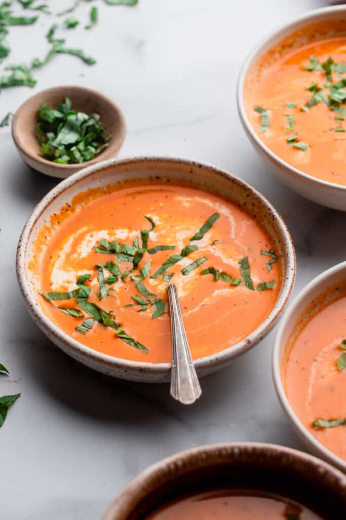 Instant Pot Tomato Soup in a bowl with basil on top