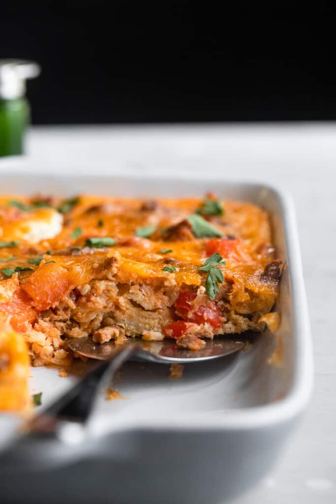 Mexican Breakfast Casserole in a baking dish with spoon