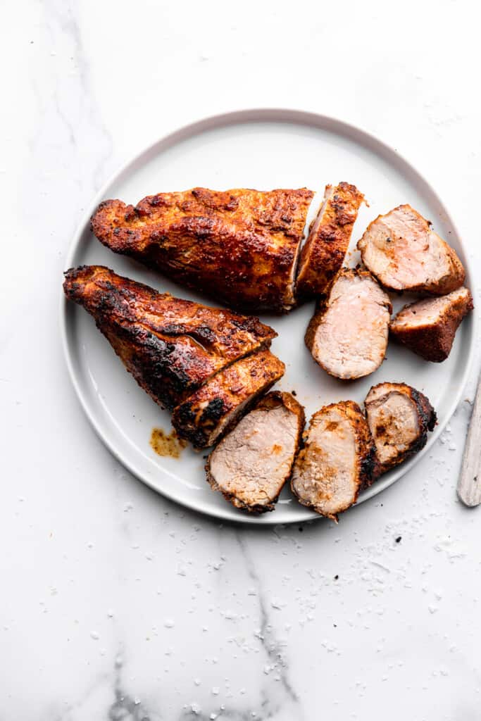 Air Fryer Pork Tenderloin cut up and placed on a large plate