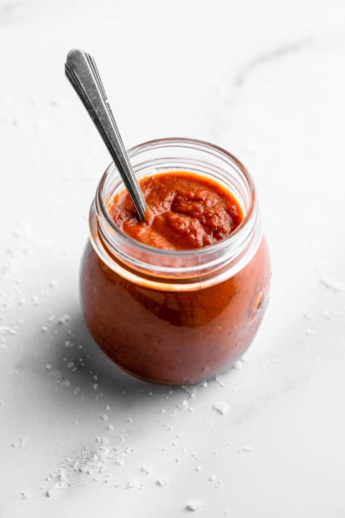 Instant Pot Tomato Sauce in a jar with a spoon inside