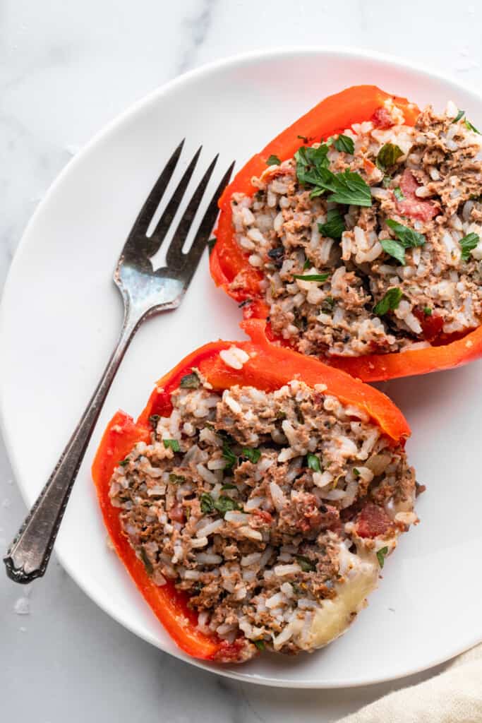 an instant pot of stuffed peppers cut open on a plate