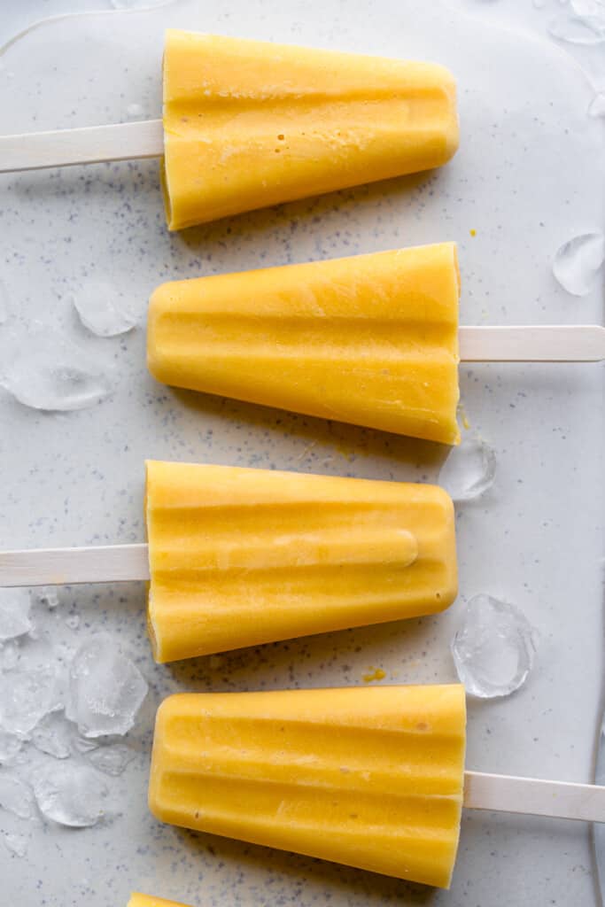 a row of Mango Popsicles with ice