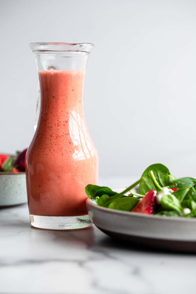 strawberry lime salad dressing in a pitcher for Strawberry Chicken Salad