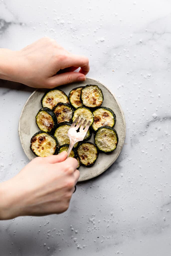 Air Fryer Zucchini being eaten off of a small plate